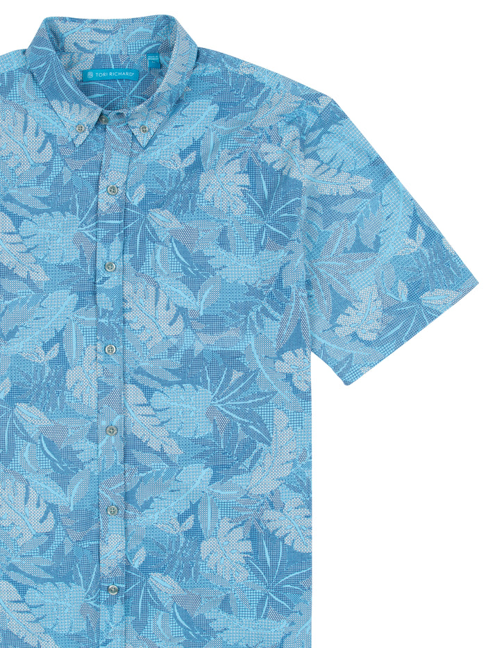 Light blue tropical leaf-print short-sleeve button-up shirt, wrinkle-resistant, front view.