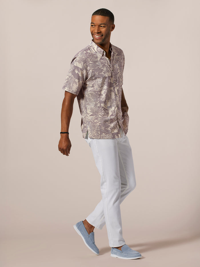 Purple patterned wrinkle-resistant long-sleeve shirt and white pants, full-body front view.
