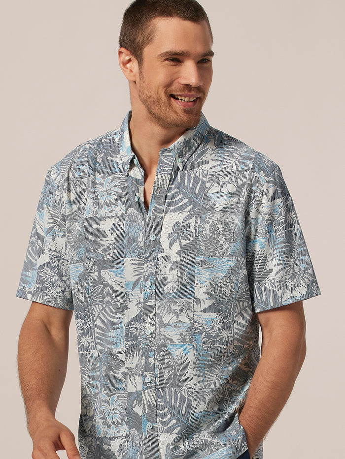 Blue and white tropical-print short-sleeve shirt, man in profile view.