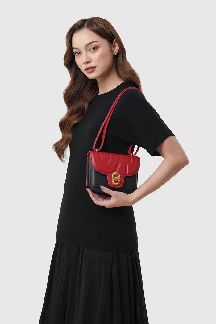 alba bag special edition shoulder bag in black/red by buttonscarves x the devil wears prada 2 carried on shoulder