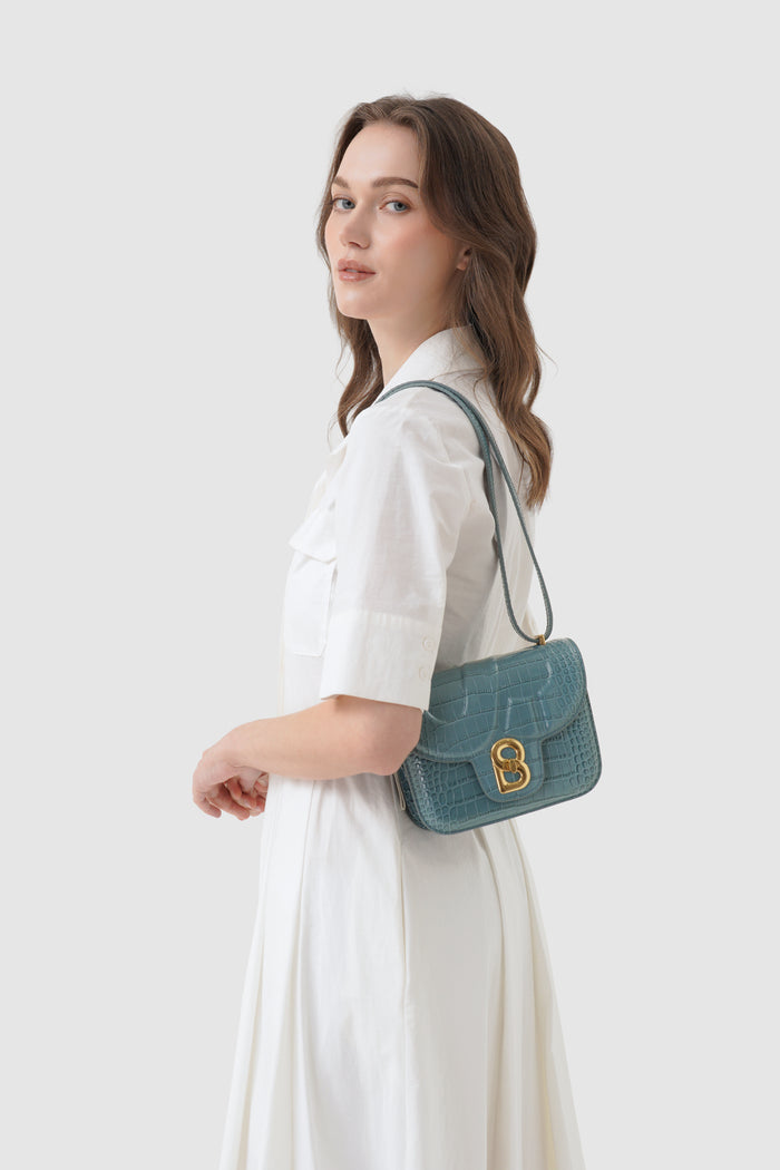 alba bag croco in dusty blue by buttonscarves worn as shoulder bag