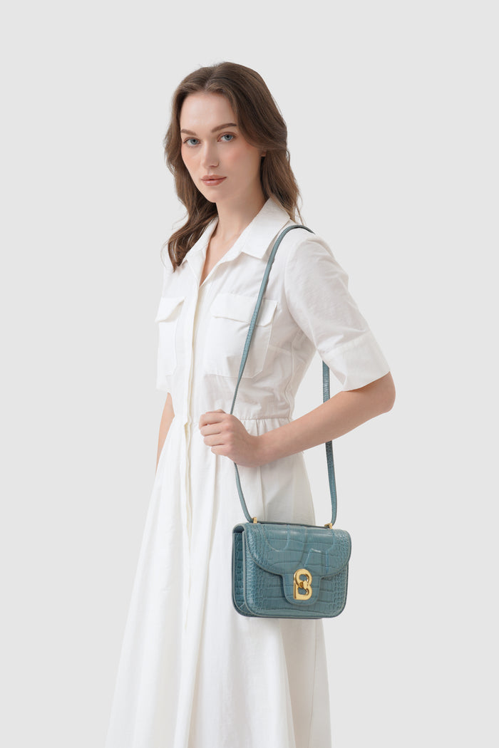 alba bag croco in dusty blue by buttonscarves worn as sling bag