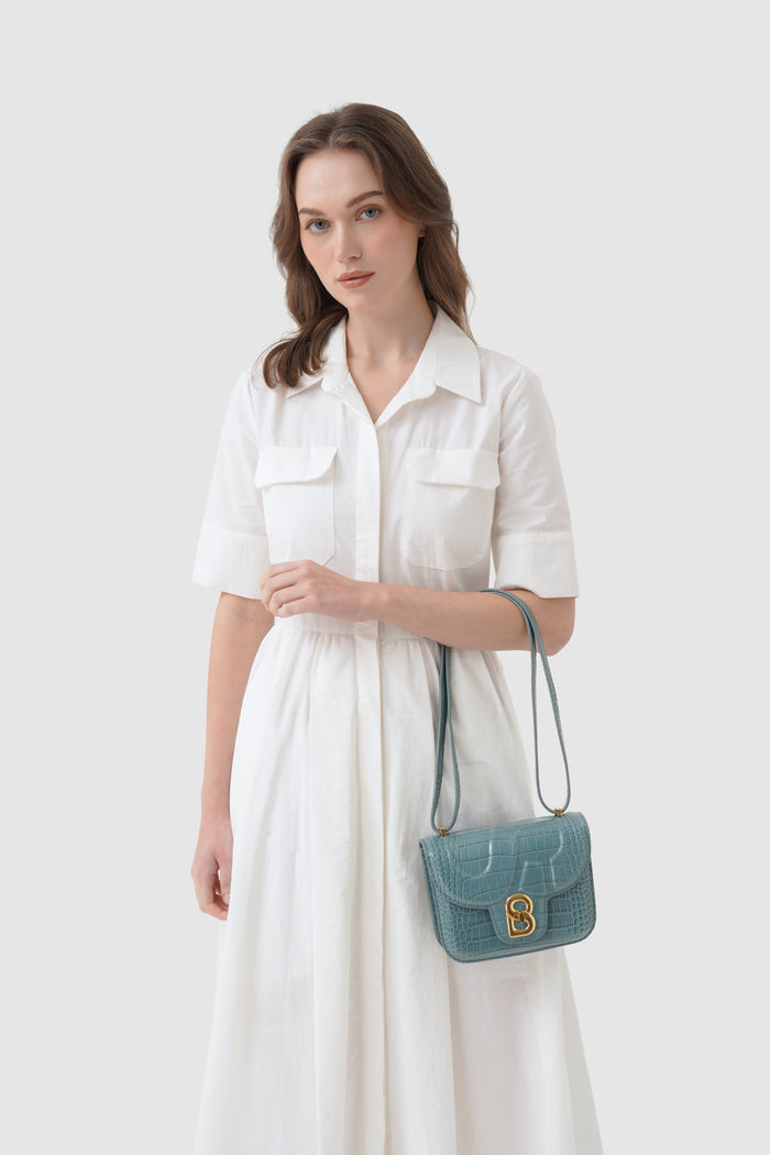alba bag croco in dusty blue by buttonscarves carried on wrist