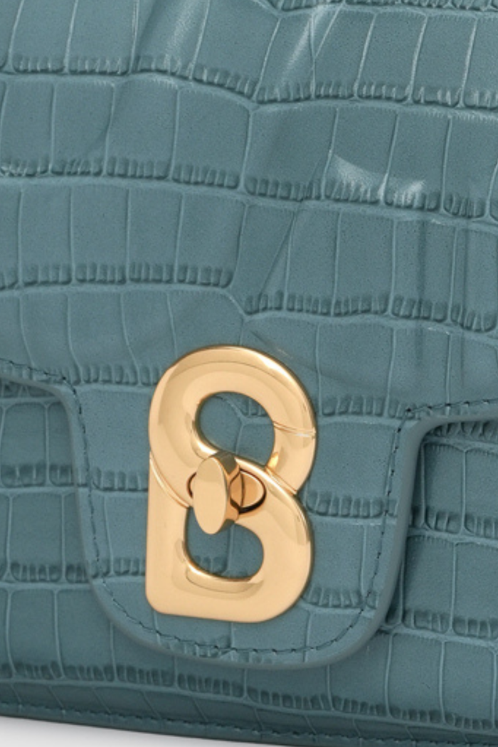 alba bag croco in dusty blue by buttonscarves signature b twist lock detail