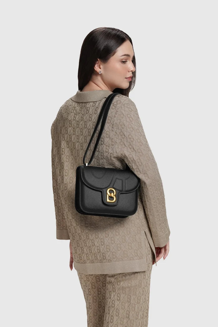 alba bag medium in black by buttonscarves worn on shoulder