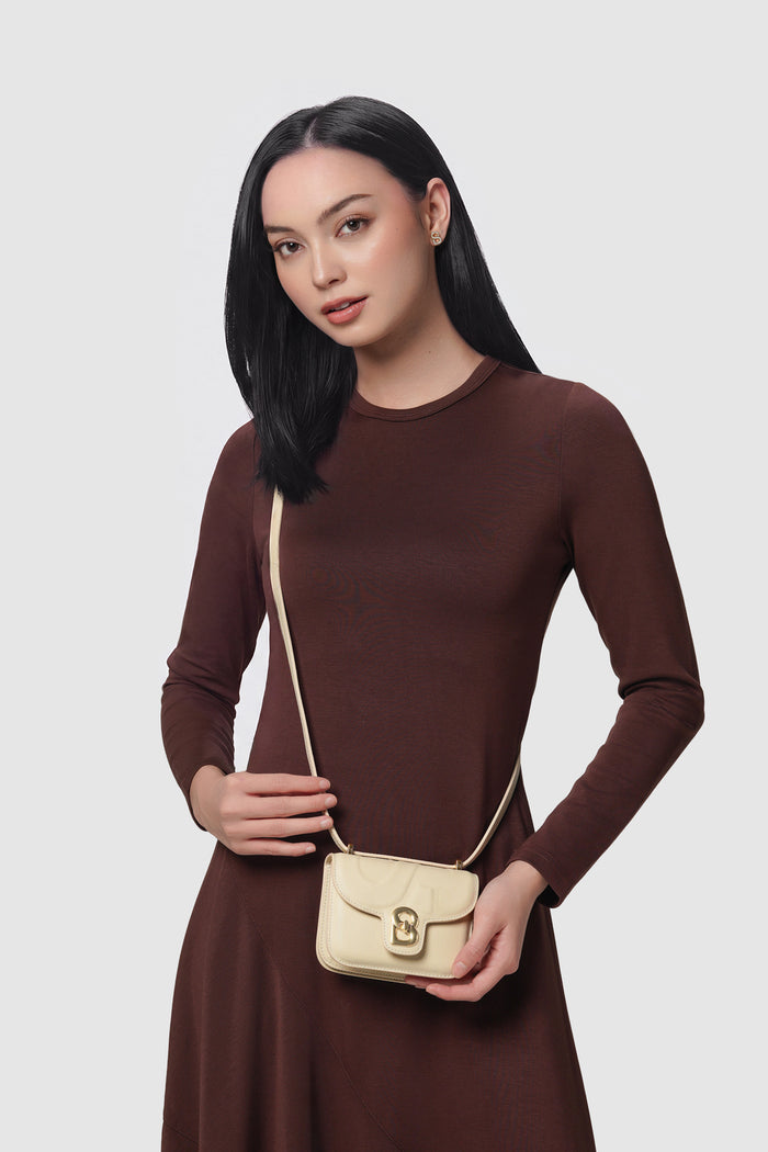 alba bag mini beige worn by a woman