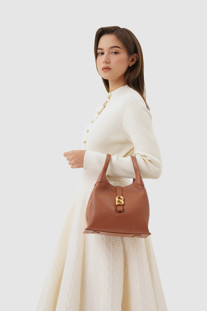 alexandra shoulder bag in caramel by buttonscarves carried on wrist