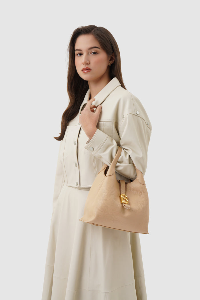 alexandra shoulder bag in champagne by buttonscarves carried on wrist