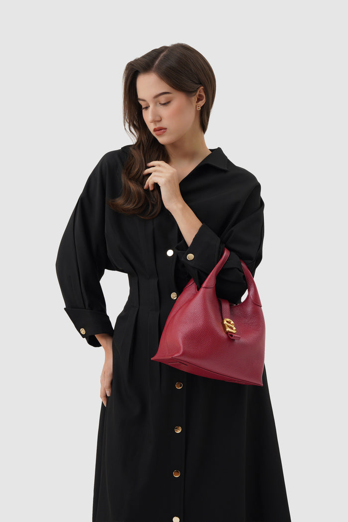 alexandra shoulder bag in cranberry by buttonscarves carried on wrist