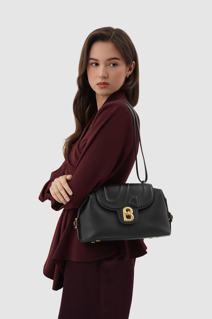 alma shoulder bag in black by buttonscarves carried on shoulder