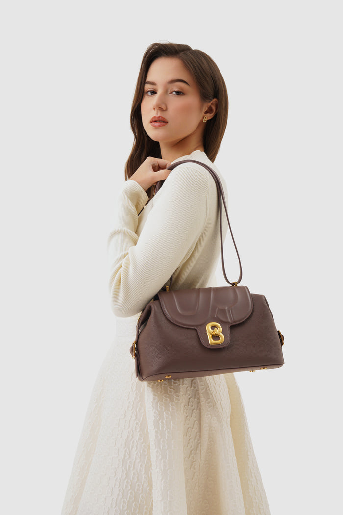alma shoulder bag in brown by buttonscarves carried on shoulder
