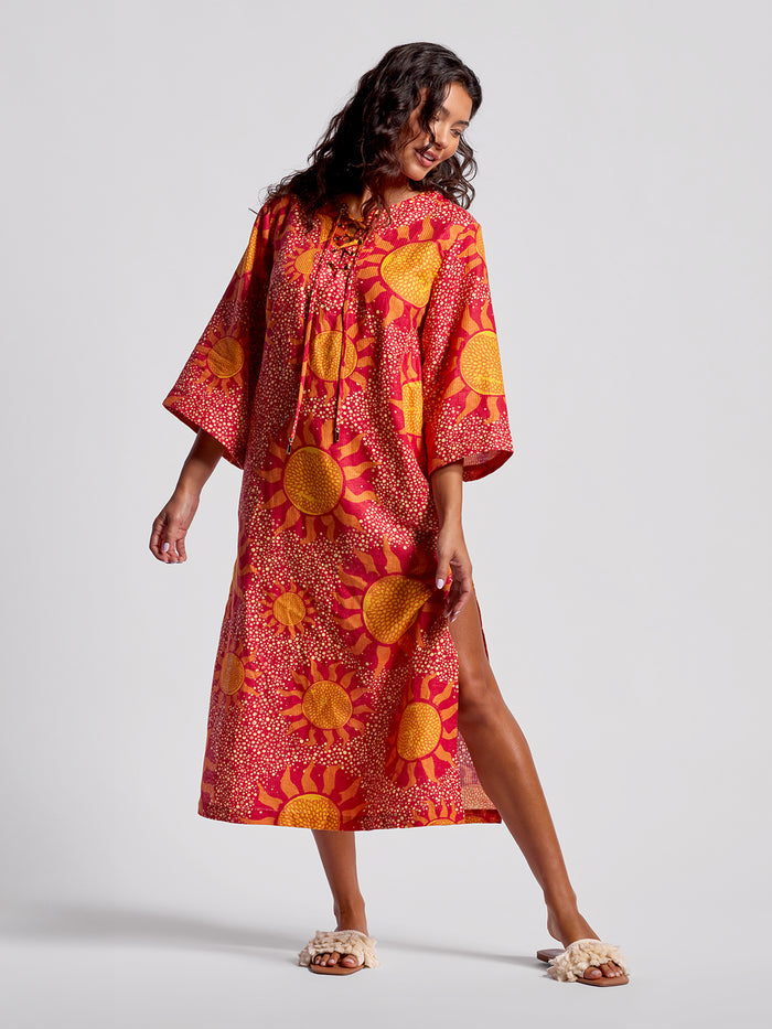 Red, yellow sun-patterned loose caftan dress, front view.