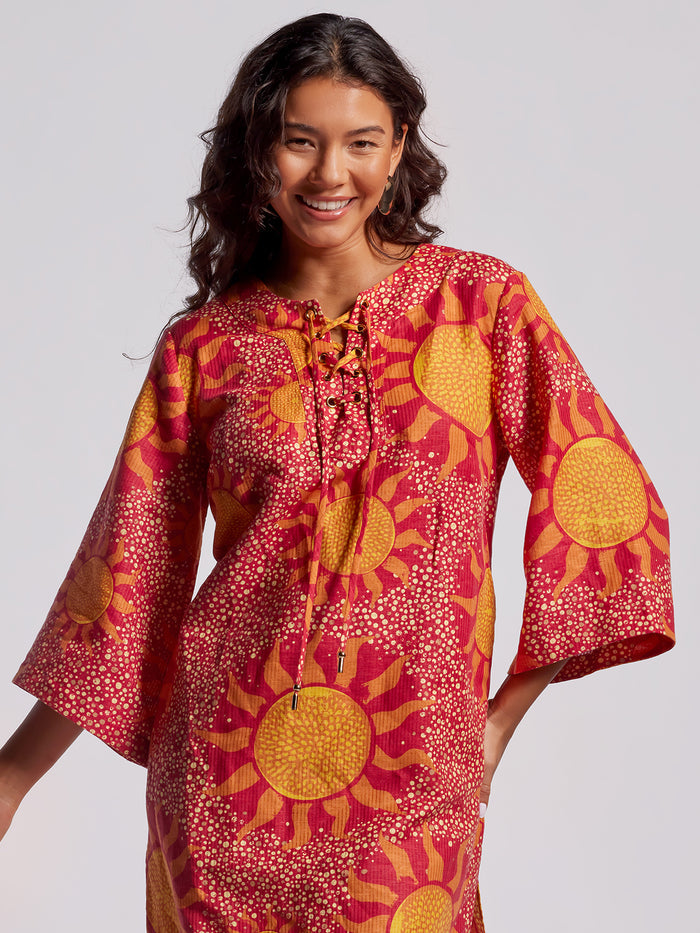 Red and yellow sun-print caftan dress with wide sleeves, modeled front view.