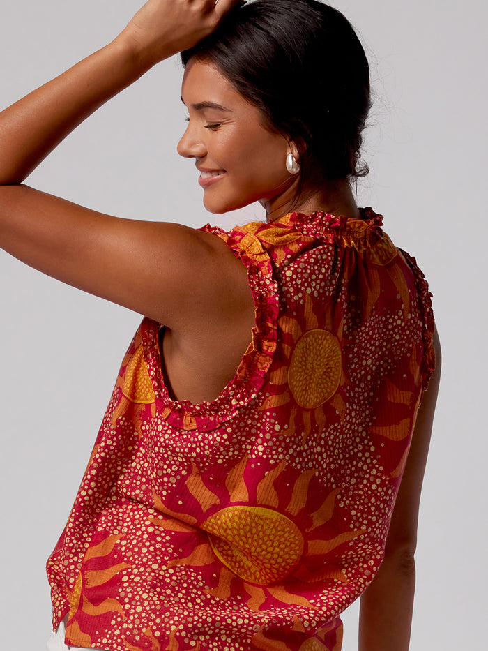 Yellow sun-pattern sleeveless blouse, front view.