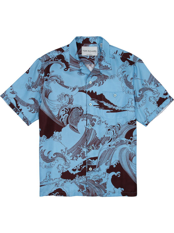 Blue wave-pattern short-sleeve silk shirt with chest pocket, flatlay front view .