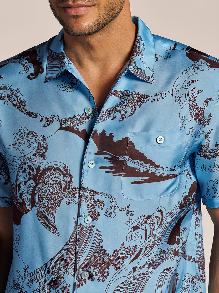 Blue silk shirt with brown wave pattern, vintage style, shoulders to chest view.