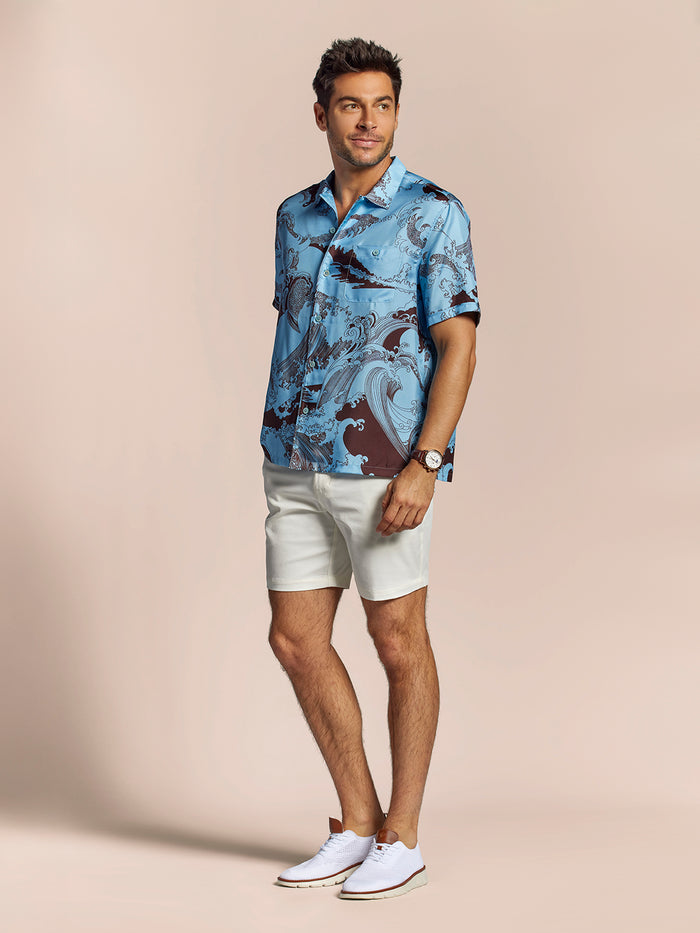 Man in blue silk short-sleeve shirt, white shorts, and shoes, front view