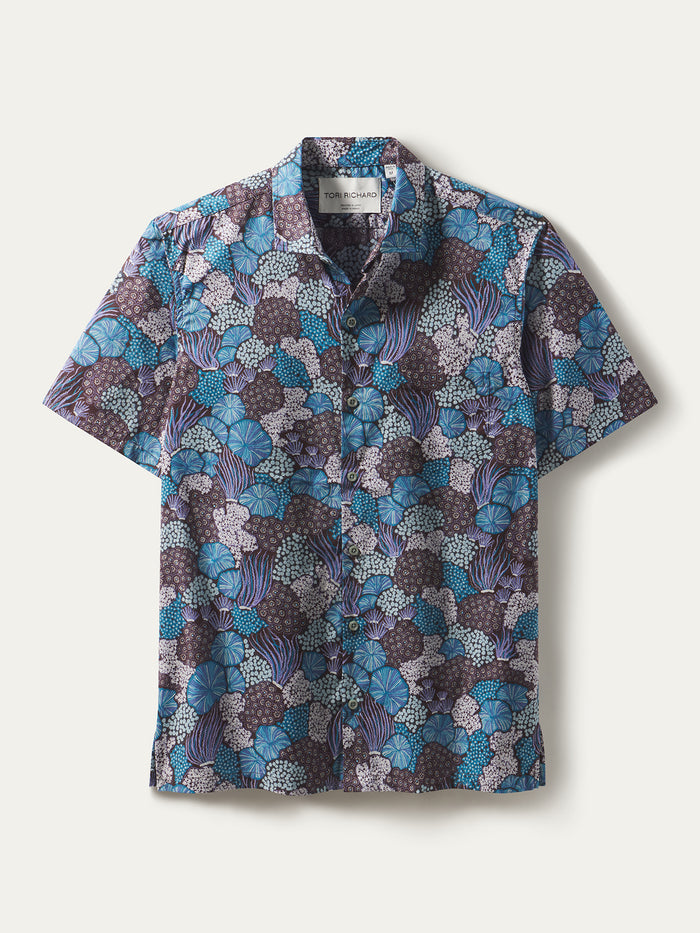 Blue, purple, and white abstract floral-print short-sleeve cotton shirt. Flat lay front view,
