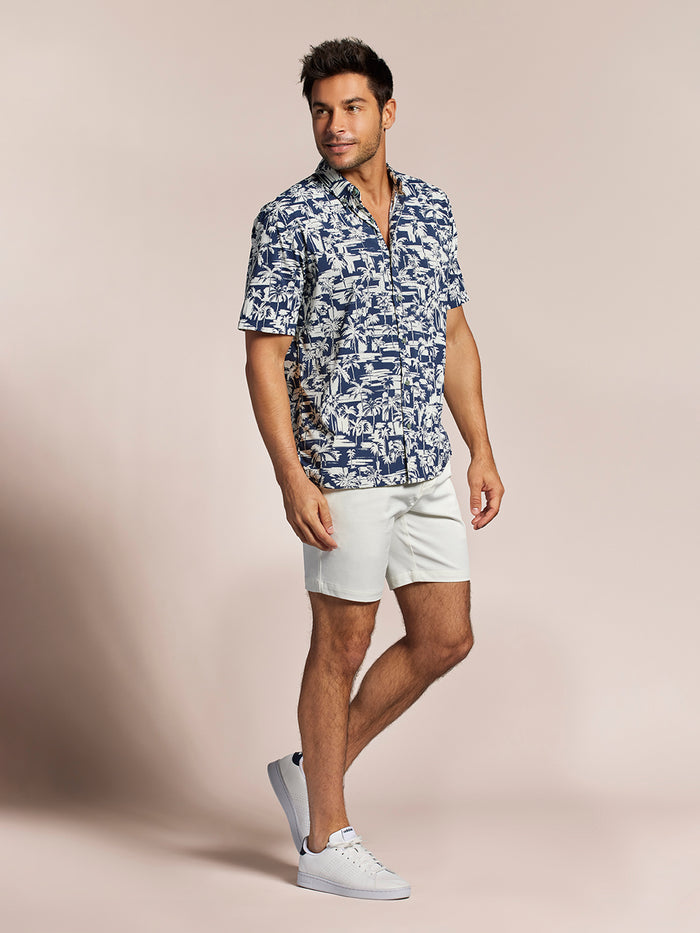 Blue short-sleeve Aperture Tradewind Technology® shirt with white shorts, full front view.