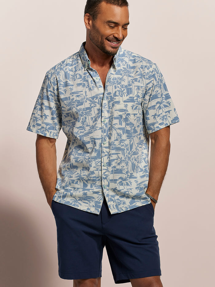 Light blue and white tropical-print short-sleeve shirt & navy shorts, front view showing fabric texture and quick-dry details.