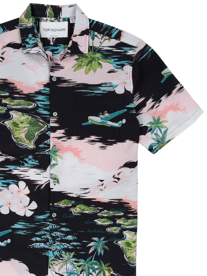 Pink, black, and green island and floral print short-sleeve Hawaiian shirt, front view.