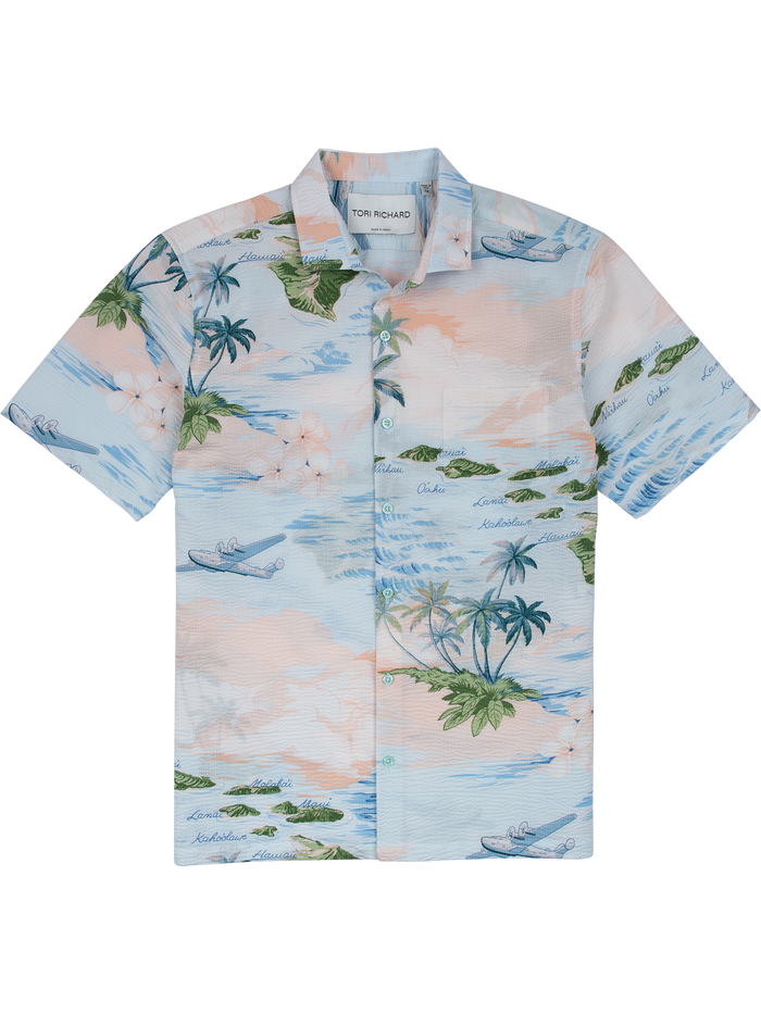 Light blue tropical palm and ocean, island and plane print cotton shirt, short sleeves, flat lay front view