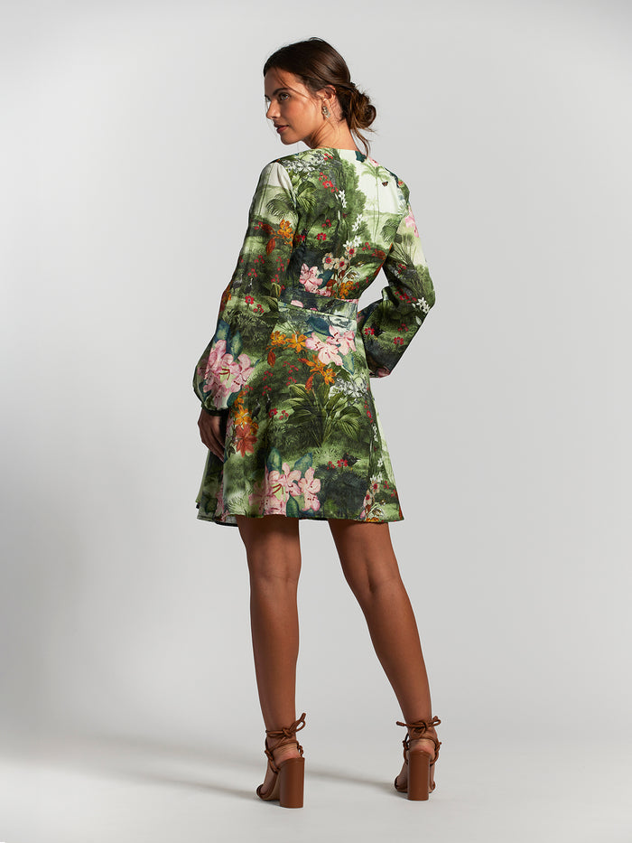 Green floral cotton voile dress, back view, modeled with brown heels.