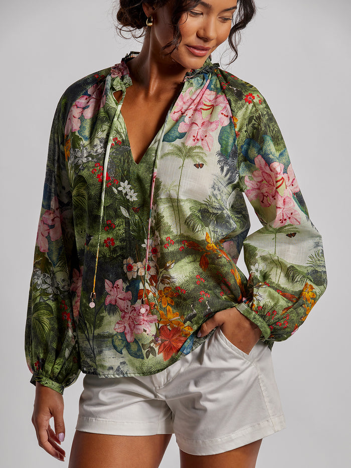 Multicolor Garden-print blouse with white shorts, front view, hand in pocket.