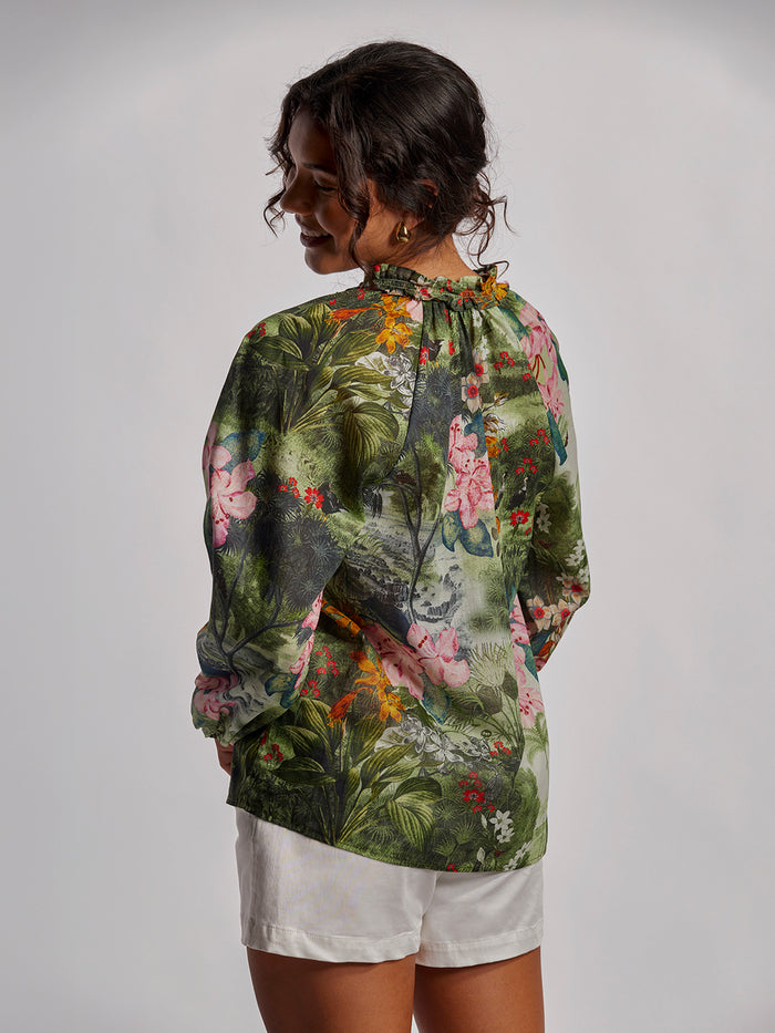 Multicolor garden-print top and white shorts, back view, on neutral background.