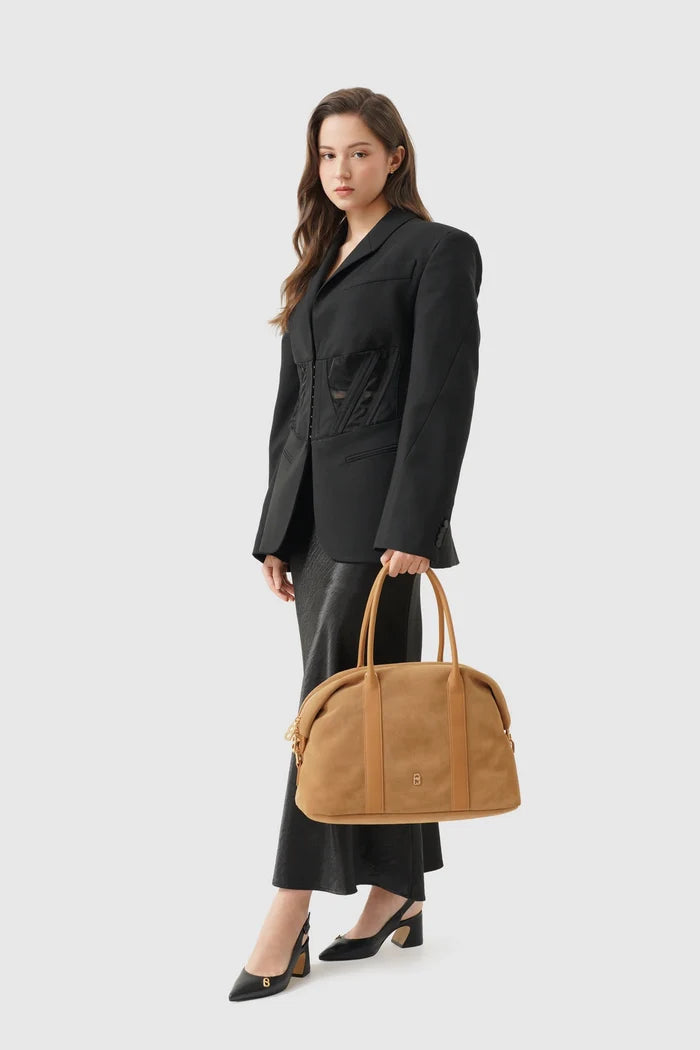 aveline bag in brown by buttonscarves carried by hand