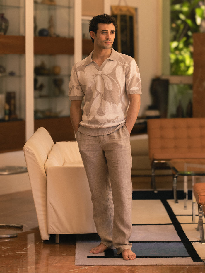 Taupe linen pant and khaki polo on model standing, front view.