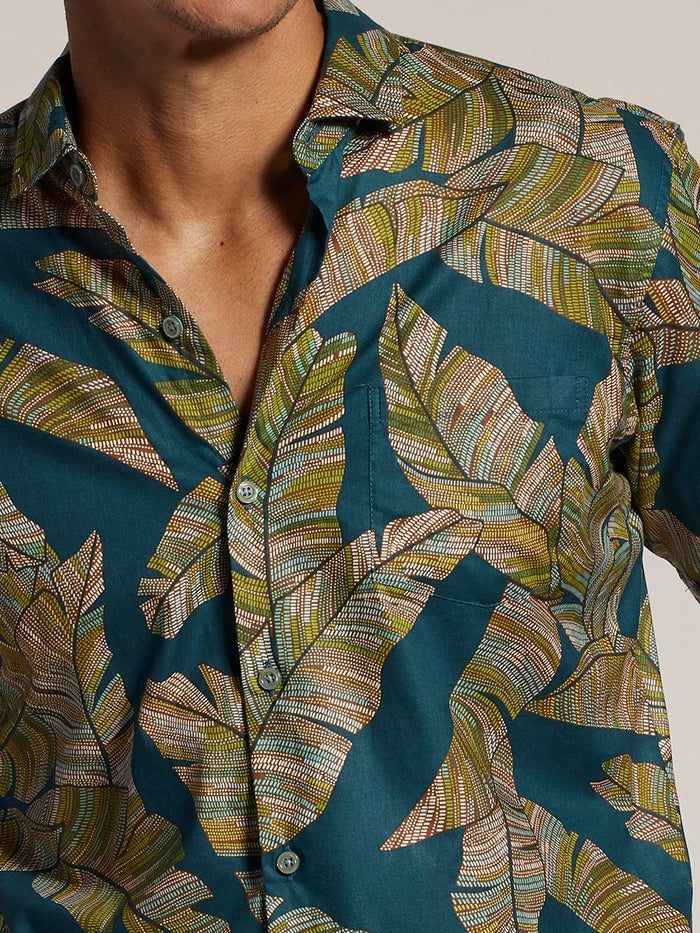 Teal shirt with green and white leaf print, Bananagraph style, shoulder-to-chest view