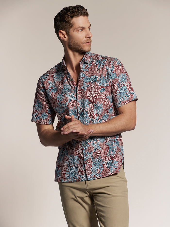 Red, blue, and white floral-print lightweight cotton shirt, side view of man.