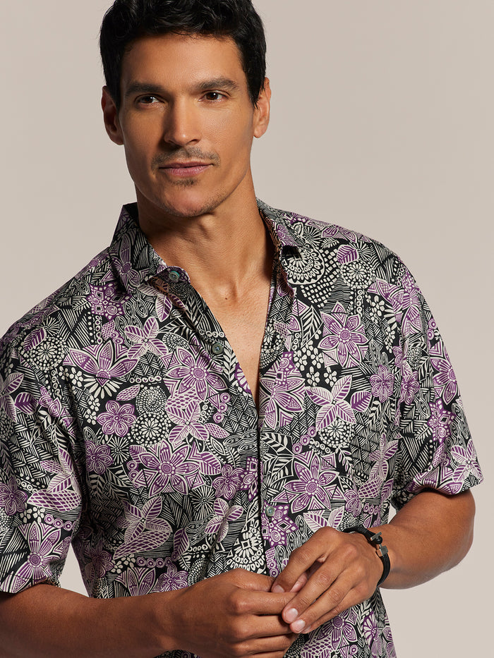 Black and purple floral-print cotton shirt, front view, plain background.