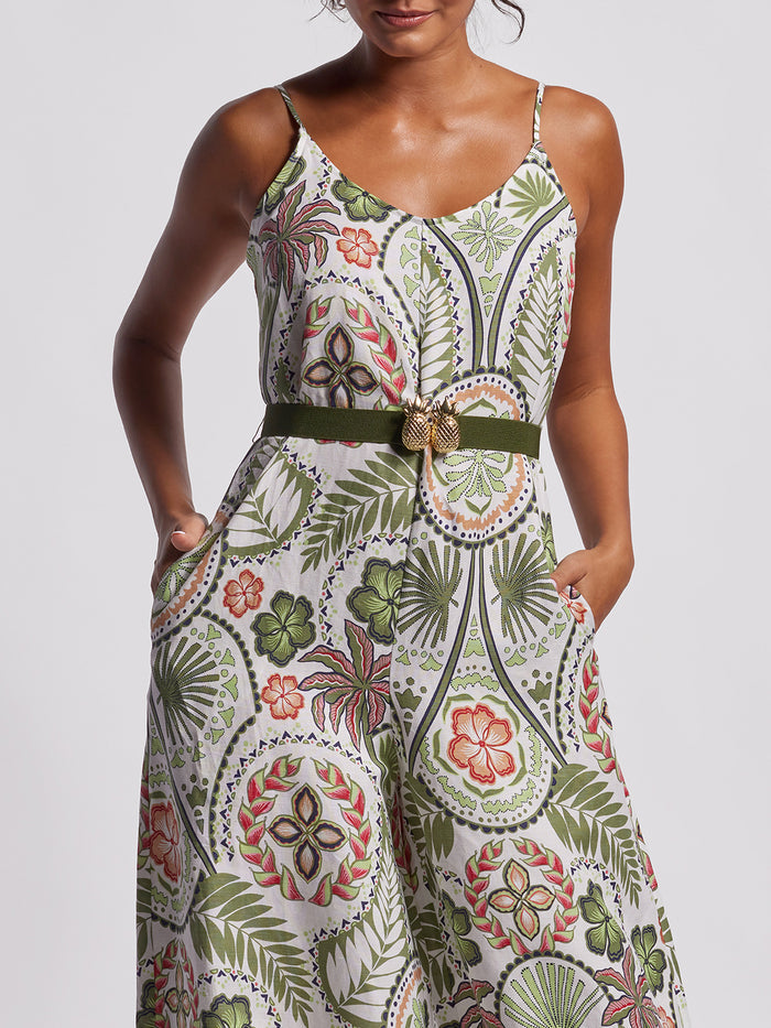 Grey solid jumpsuit multi color floral print with statement belt, hands in pockets, full front view.