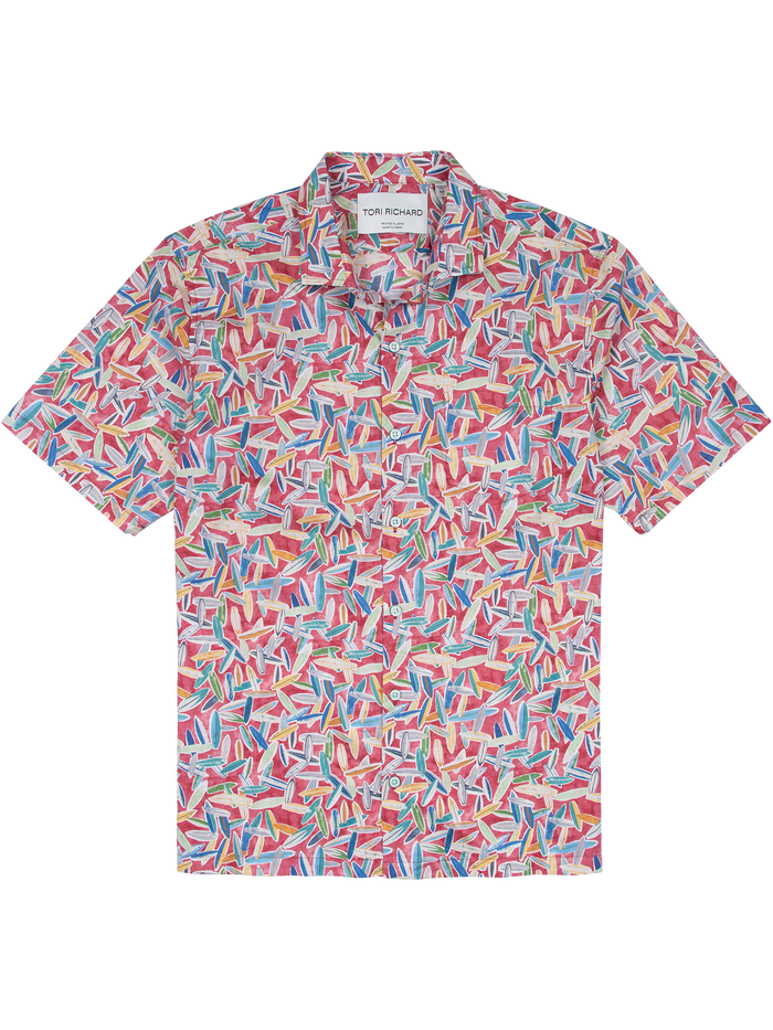 Red, blue, yellow, and white geometric-surfboard print short-sleeve shirt, front view of flat lay.