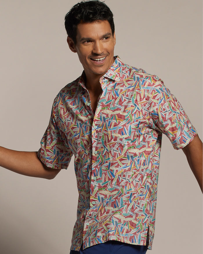 White and blue geometric- surfboard print short-sleeve shirt, front view of shirt on a model.