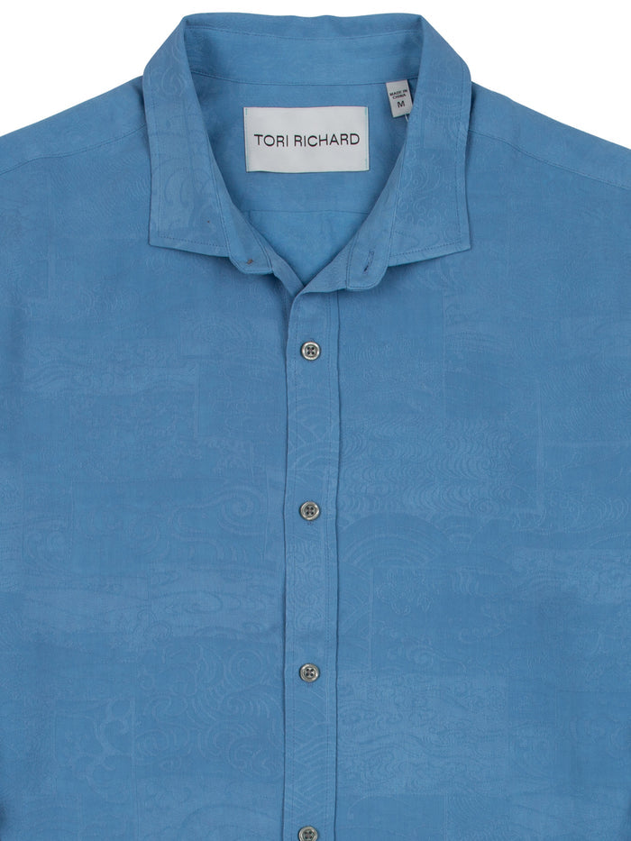 Blue jacquard wave-pattern long-sleeve shirt with collar, front view.