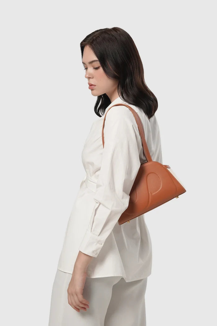 bora shoulder bag in brown by buttonscarves carried on shoulder