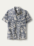 White short-sleeve button-up shirt with blue plumeria print, flat lay front view.