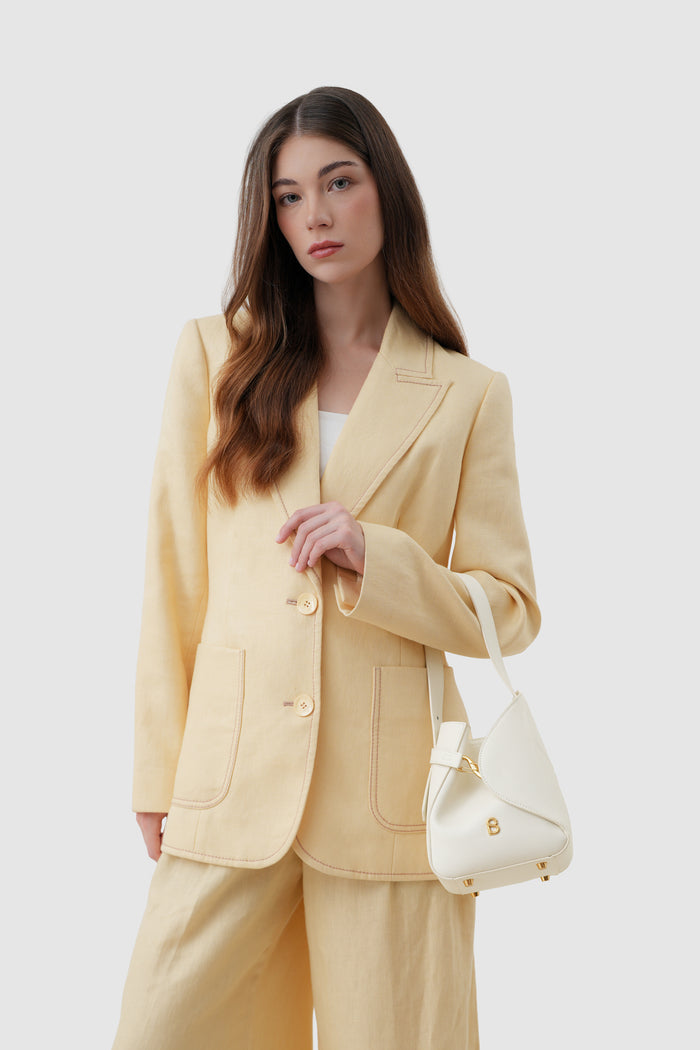 britney bag small with saffiano leather in bianco candido by buttonscarves carried on wrist