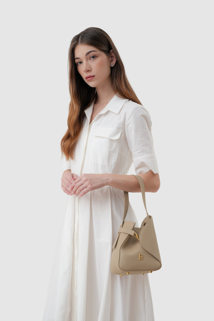 britney bag small with saffiano leather in clay by buttonscarves carried on wrist