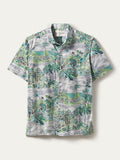 White shirt with green and brown palm tree landscape nature print, short sleeves, shown in flat lay front view.