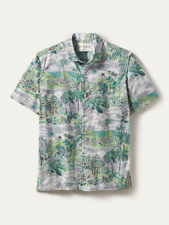 White shirt with green and brown palm tree landscape nature print, short sleeves, shown in flat lay front view.