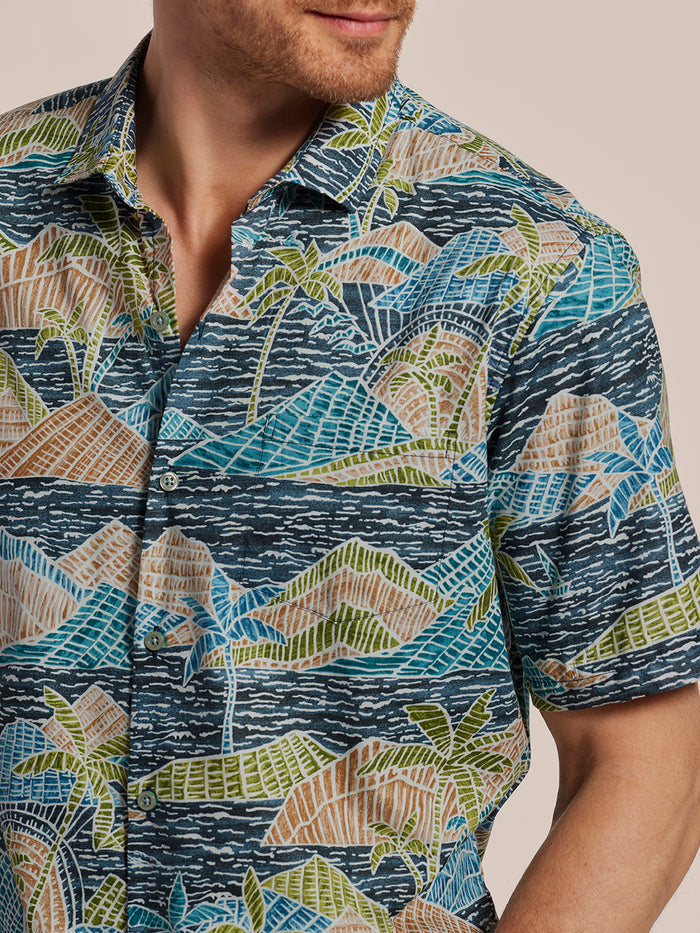 Multicolor tropical island and palm tree print short-sleeve shirt, front view.