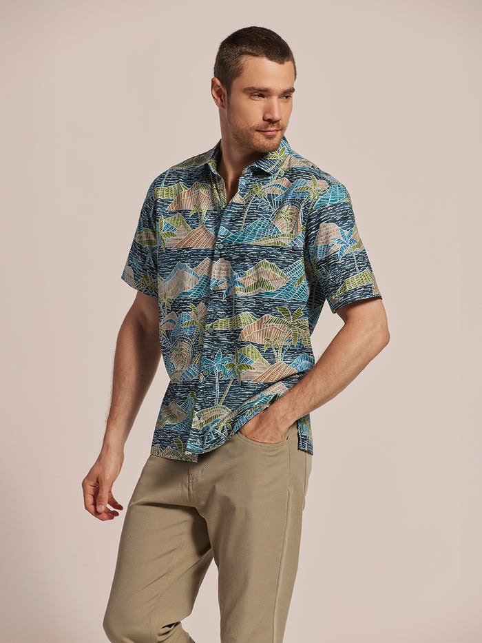 Multicolored graphic-print cotton short-sleeve shirt and beige pants, front view.
