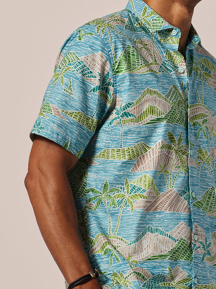 Blue cotton Hawaiian shirt, green palm leaf print, short-sleeve, front view.