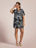 Black and white leaf-print Monica dress, full-length front view with white heels.