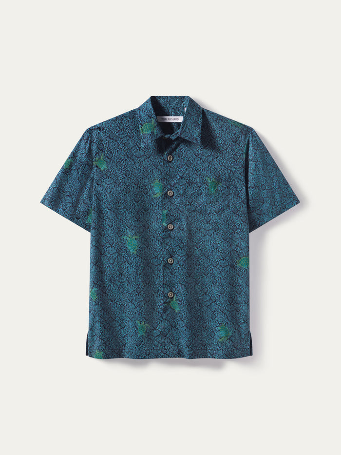 Blue short-sleeve shirt with subtle green-accent pattern, front view.
