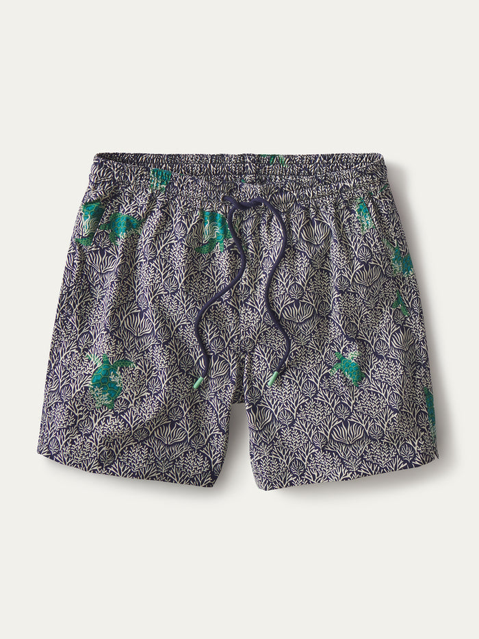 Navy and white coral-print swim short with green fish accents, elastic waist, and drawstring, front view.